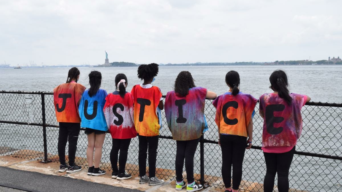 children with shirts spelling "Justice"